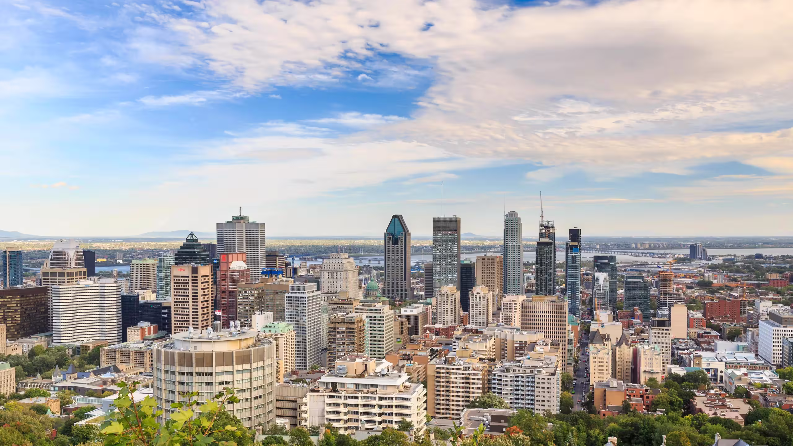 Mount Royal panoramic view over Montreal skyline and St. Lawrence